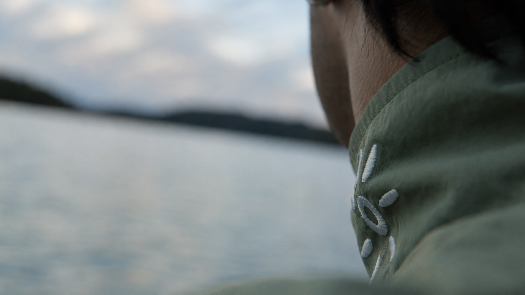 Sun's Out sun embroidery on the sage wind jacket collar by the lake