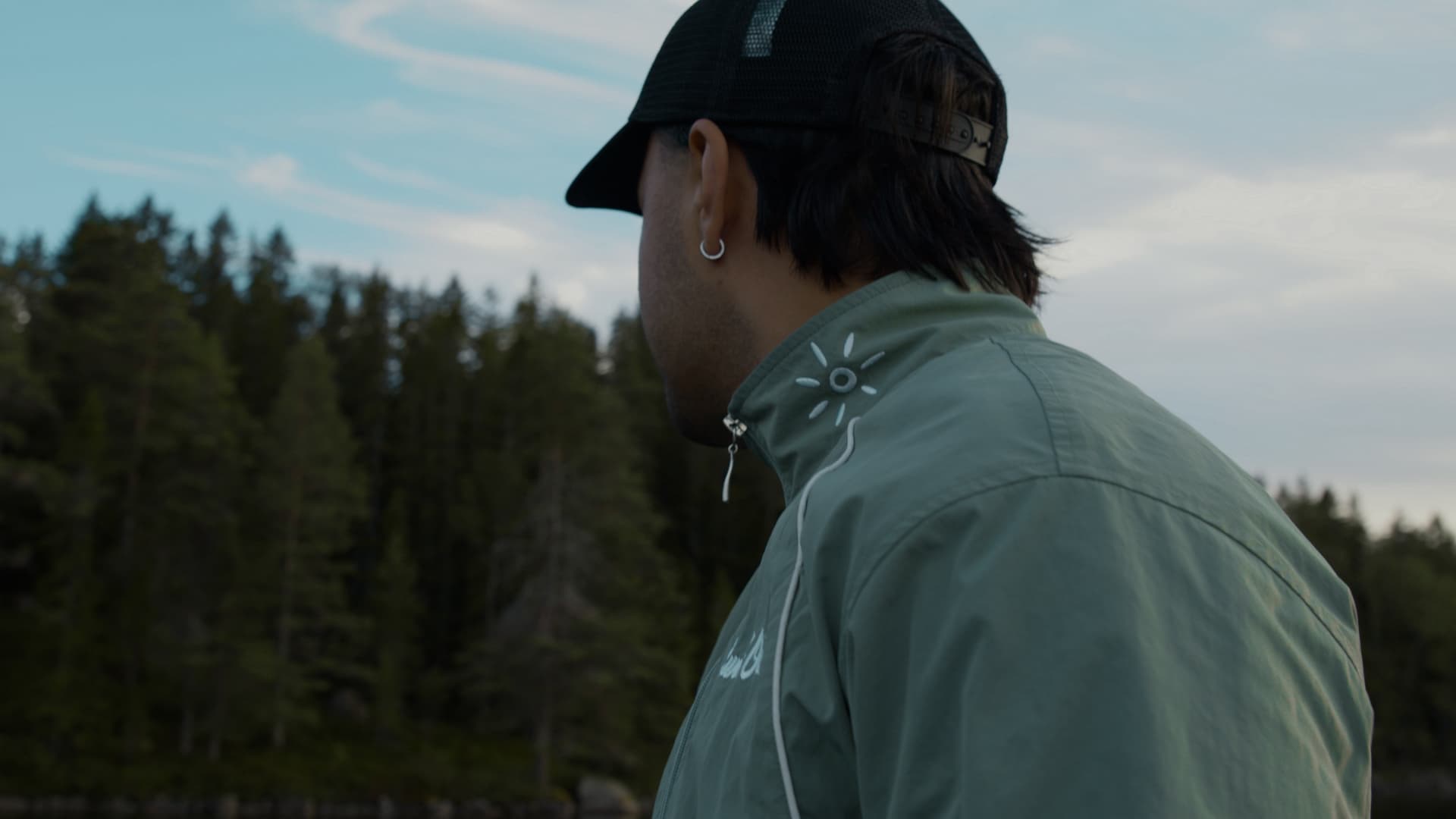 Sun's Out Golf sage wind jacket by the lake